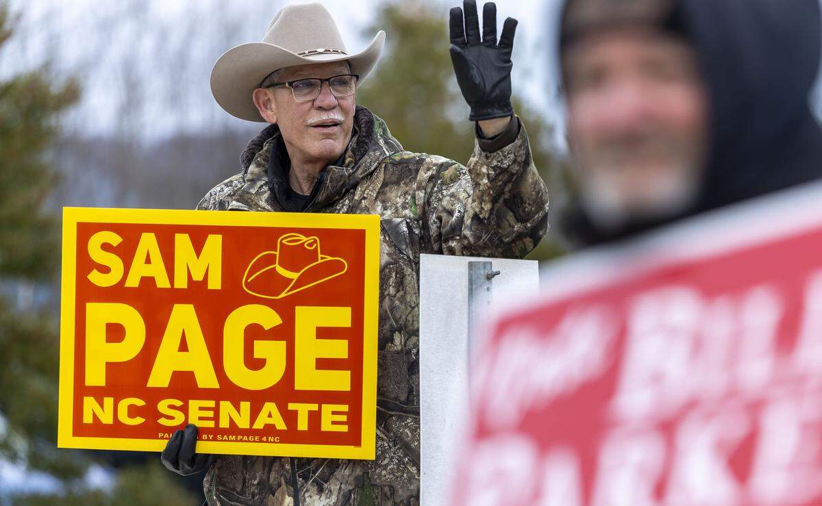 Rockingham County Sheriff  Sam Page, a candidate for NC Senate, waves to voters as they arrive to cast their ballots at the Madison-Mayodan Public Library polling site on Tuesday, February 24, 2026 in Madison, N.C. Page is challenging NC Senator Phil Berger in the 2026 primary. 