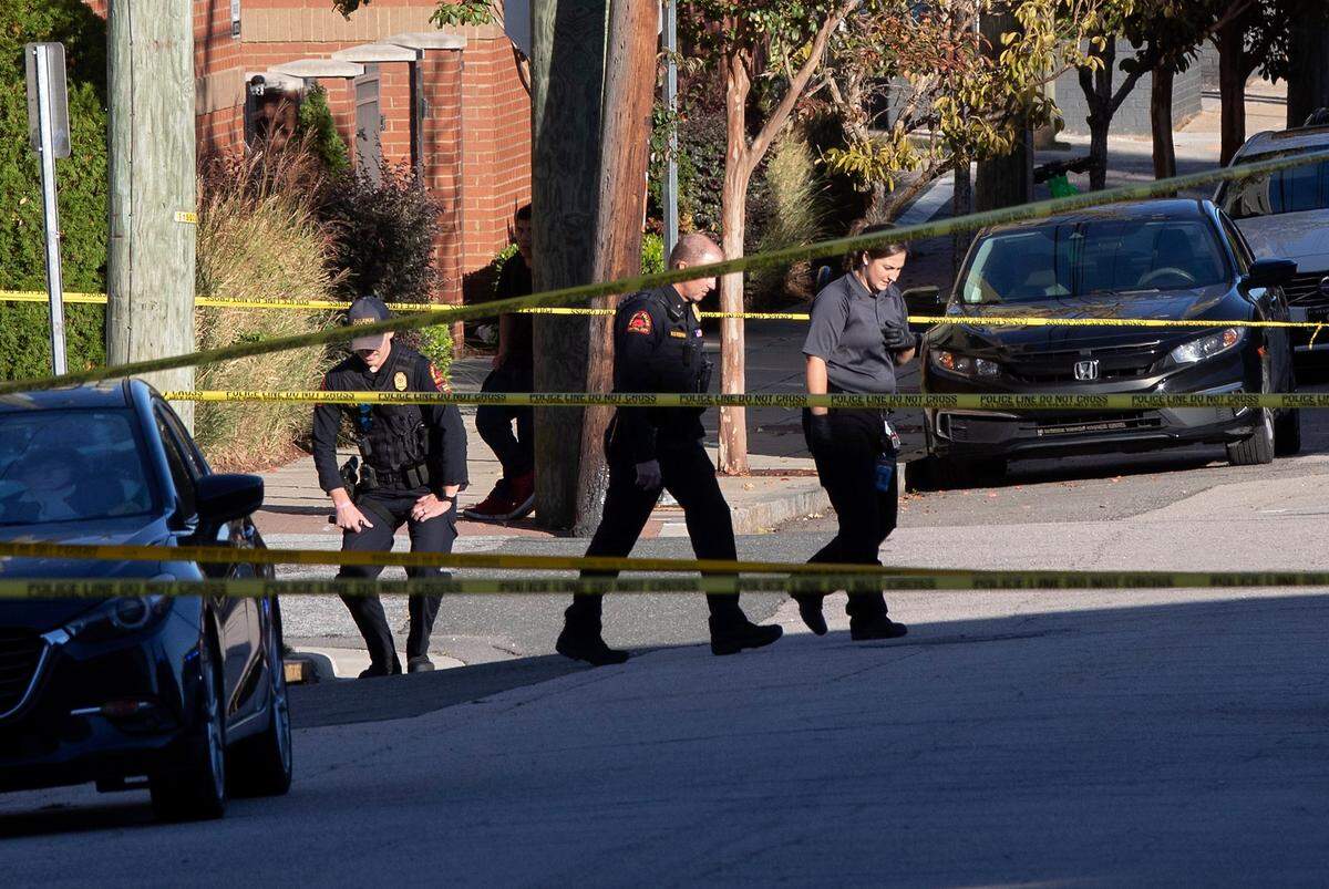Law enforcement work near the scene of shooting at the intersection of Martin and Bloodworth Streets in Raleigh, N.C. on Monday, Oct. 23, 2023.