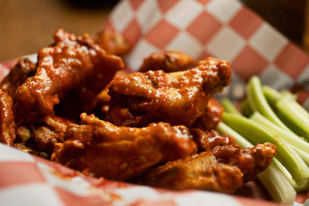 You have a choice of 14 different sauces, including blazing buffalo pictured here, for Woody’s jumbo wings at Woody’s at City Market in Raleigh.