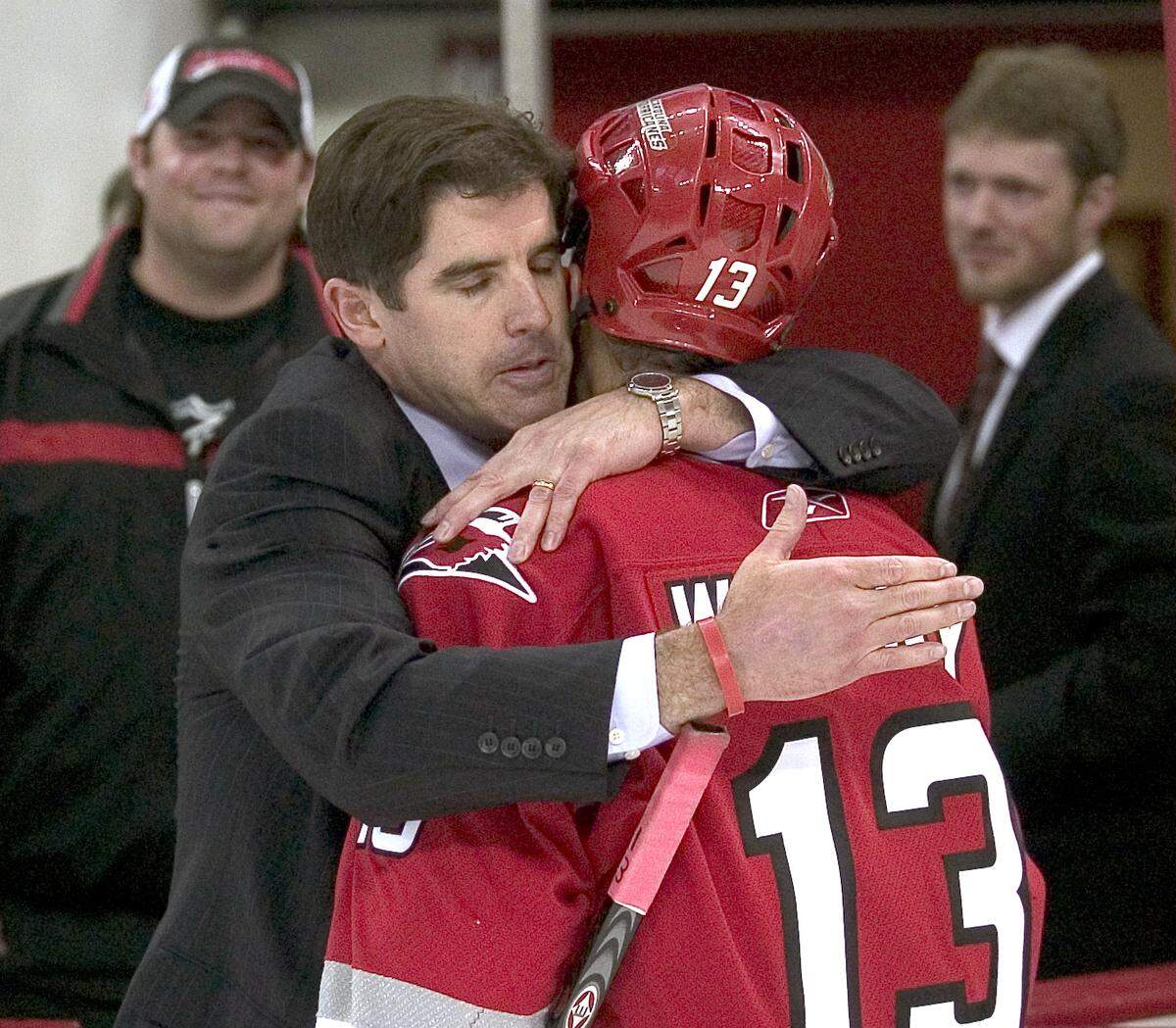 Carolina Hurricanes coach Peter Laviolette hugs Ray Whitney (13) following the Hurricanes 4-1 victory over New Jersey on Sunday May 14, 2006 in the RBC Center.   stf/Robert Willett