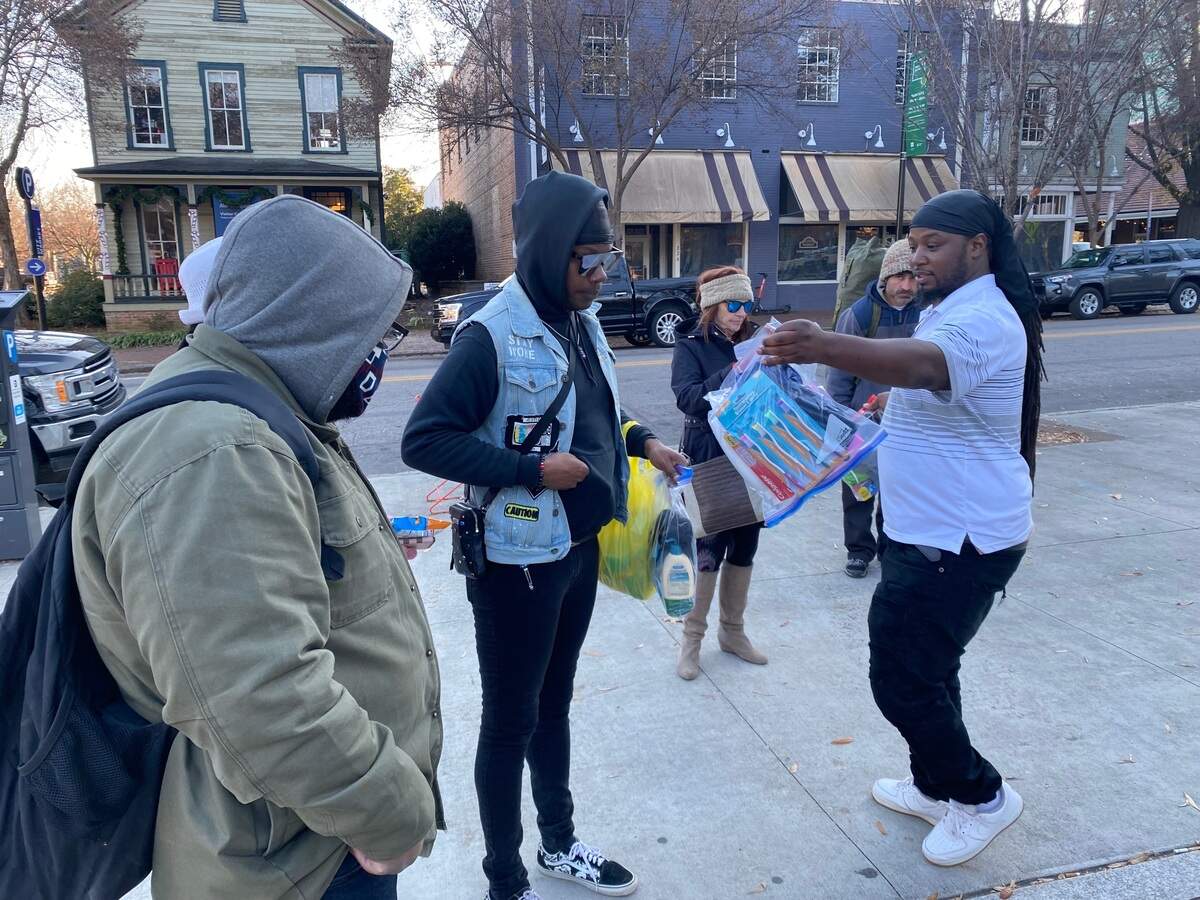 Brandon Anderson, 35, hands out a hygeine kit in Moore Square in downtown Raleigh Tuesday as part of his ongoing efforts to assist Raleigh’s homeless.