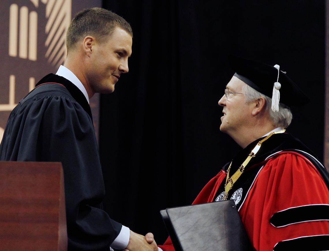 Former Wolfpack football star Philip Rivers is thanked by N.C. State Chancellor W. Randolph Woodson after he finishes the commencement address at the PNC Arena in Raleigh, N.C. Saturday May 12, 2012
