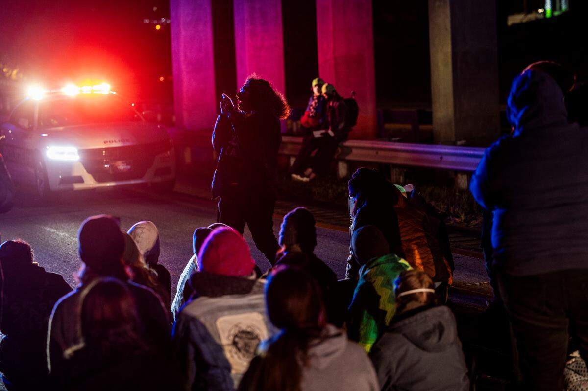 Protesters attempt to call in to a telephone town hall hosted by U.S. Rep. Valerie Foushee while they block the northbound lanes of the Durham Freeway at the South Magnum Street bridgeThursday evening, Nov. 2, 2023 demanding a ceasefire in the Israel-Gaza War.