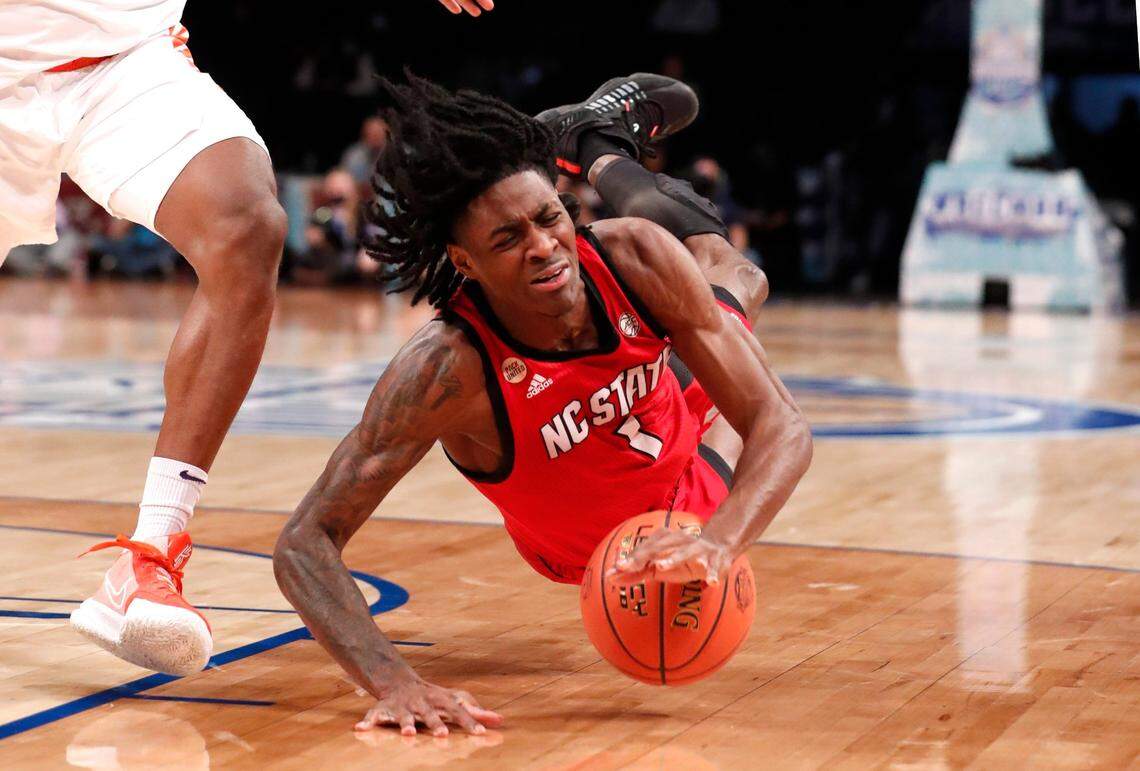 N.C. State’s Dereon Seabron (1) falls after being fouled during the first half of N.C. States game against Clemson in the first round of the ACC mens basketball tournament at the Barclays Center in Brooklyn, N.Y., Tuesday, March 8, 2022.