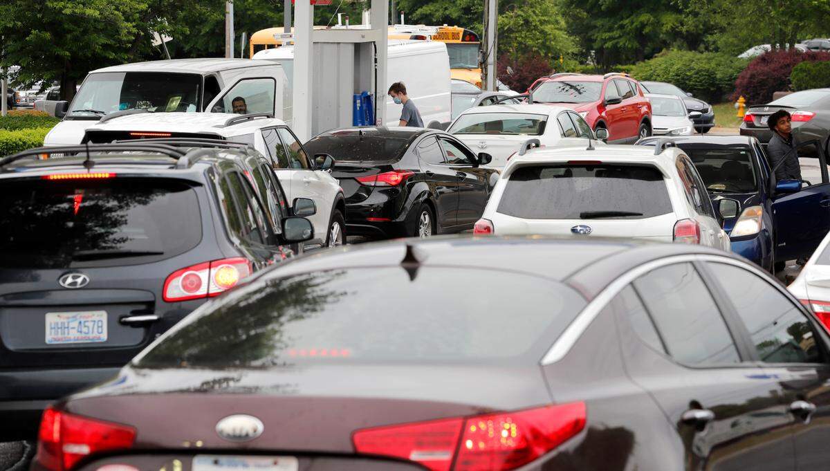 Customers line up to get gas at the Mobil station on S. Saunders Street in Raleigh, N.C. Wednesday, May 12, 2021. The station was the only one in the area that had gas available.