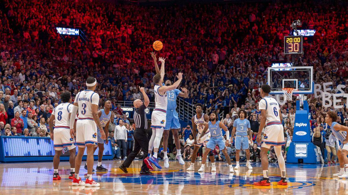 North Carolina forward Jalen Washington (13) and Kansas center Hunter Dickinson (1) tip off the first game between the two schools at Allen Fieldhouse since 1961, on Friday, November 8, 2024 in Lawrence, Kansas.