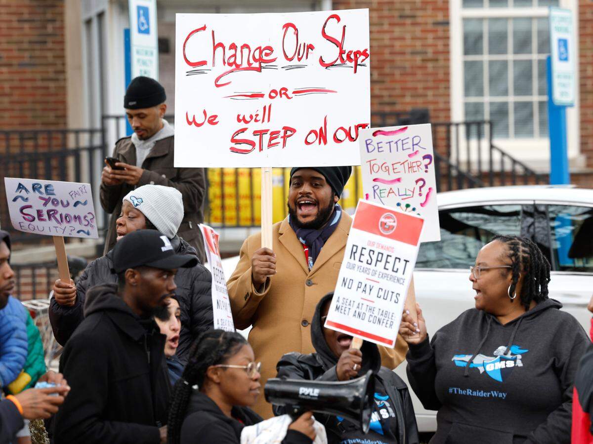 LaRoy Morton, a cafeteria manager at Githens Middle School, center, and others protest outside the Durham Public Schools administrative building in Durham, N.C., Wednesday, Jan. 31, 2024. Twelve Durham public schools were closed Wednesday as staff — furious about unresolved salary issues — called in sick to attend protests.