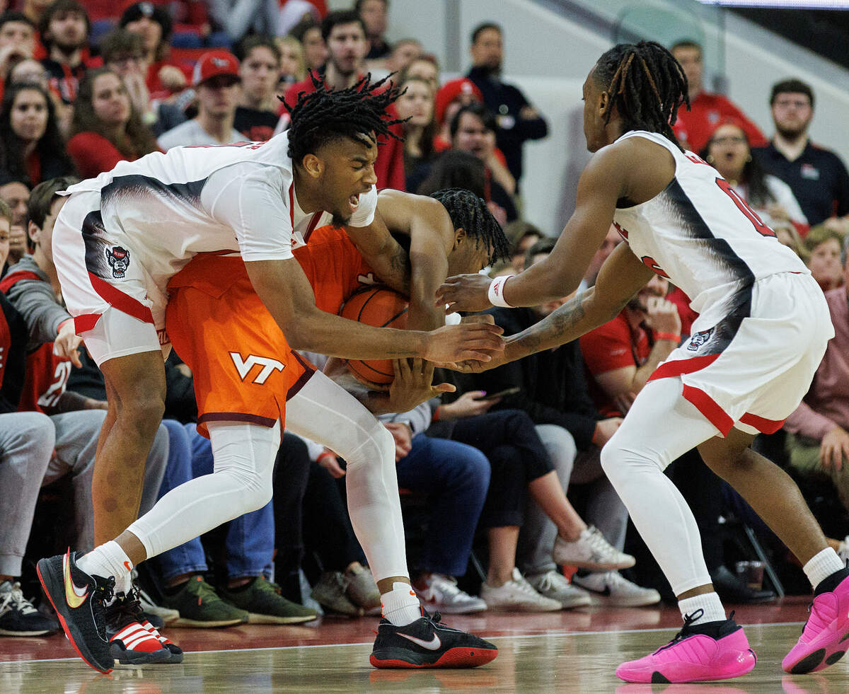 N.C. State’s Jayden Taylor and DJ Horne trap Virginia Tech’s MJ Collins to force a jump ball during the second half of the Wolfpack’s 84-78 loss on Saturday, Jan. 20, 2024, at PNC Arena in Raleigh, N.C.