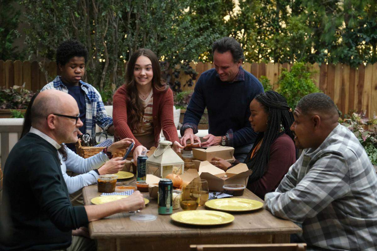 Characters on the CBS show “The Unicorn” enjoy some North Carolina barbecue and beer from Raleigh’s Trophy Brewing Co., in a March 11 episode of the show. Pictured (L-R): Rob Corddry as Forrest, Michaela Watkins as Delia, Devin Bright as Noah, Ruby Jay as Grace, Walton Goggins as Wade, Maya Lynne Robinson as Michelle, Omar Miller as Ben.