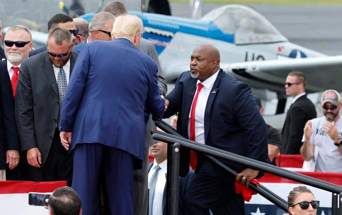 Republican candidate for president Donald Trump greets N.C. Republican candidate for governor Mark Robinson at the start of former President Trump’s speech in Asheboro, N.C., Wednesday, August 21, 2024.