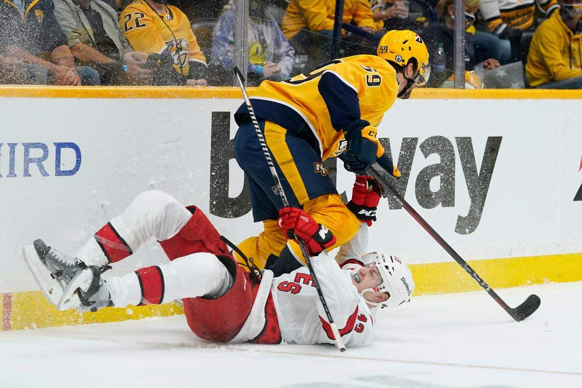 Nashville Predators defenseman Roman Josi (59) and Carolina Hurricanes left wing Warren Foegele (13) collide during the first period in Game 3 of an NHL hockey Stanley Cup first-round playoff series Friday, May 21, 2021, in Nashville, TN.