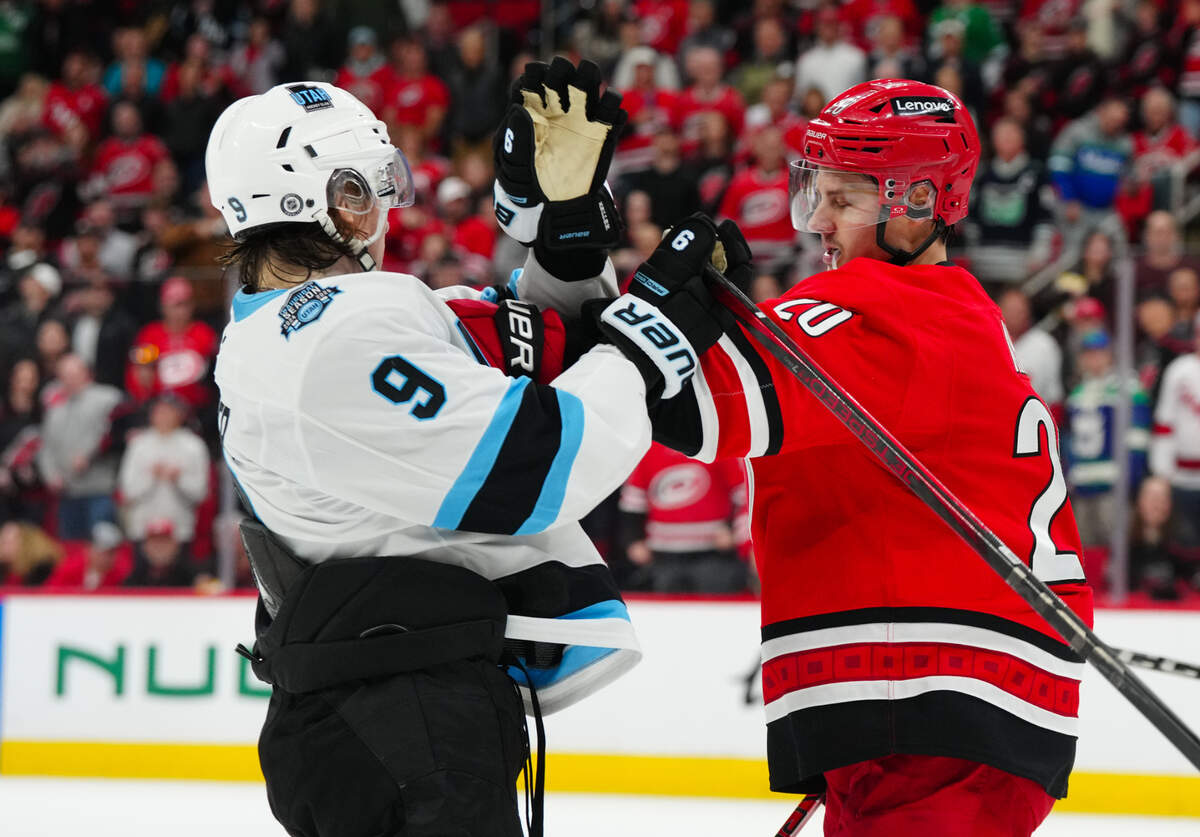 Carolina Hurricanes center Sebastian Aho (20) shoves Utah Hockey Club center Clayton Keller (9) during the second period at Lenovo Center.