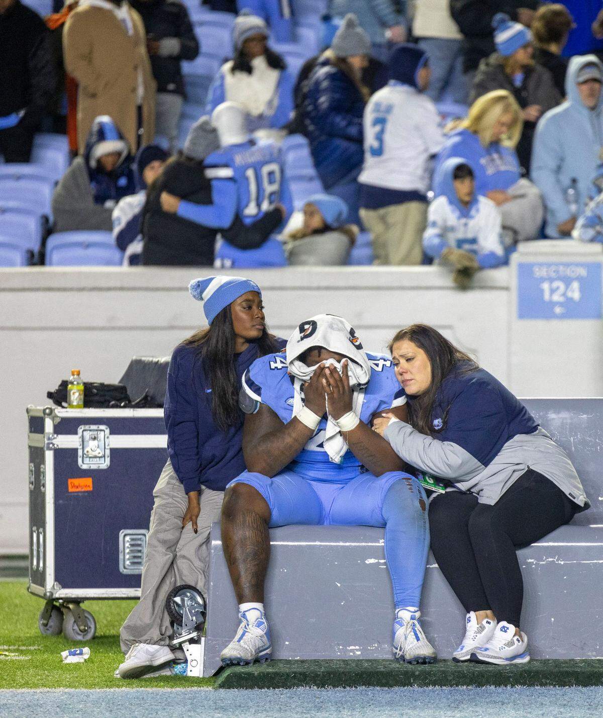 North Carolina defensive lineman Travis Shaw (4) is consoled on the Tar Heels’ bench following their 35-30 loss to N.C. State on Saturday, November 30, 2024 at Kenan Stadium in Chapel Hill, N.C.