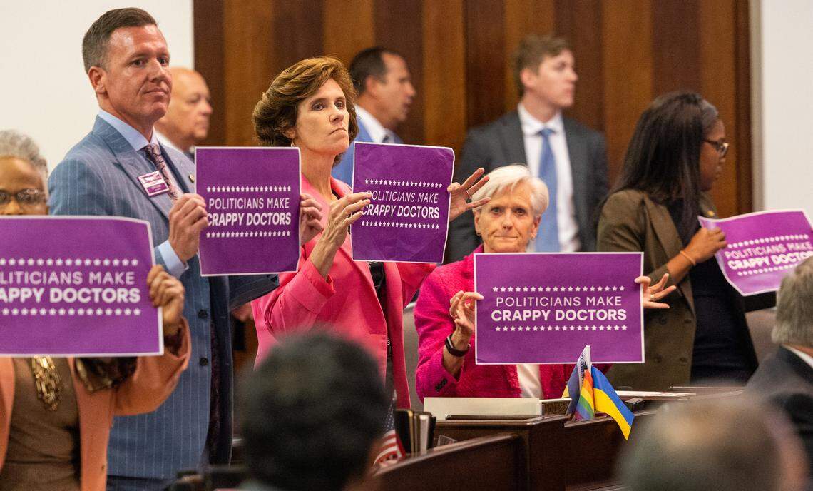 Democratic senators hold signs after a vote on an abortion restrictions bill that was up for a veto override on Tuesday, May 16, 2023, at the Legislative Building in Raleigh, N.C. Republicans have a veto-proof supermajority in the General Assembly, with the ability to overturn a veto from Democratic Gov. Roy Cooper.