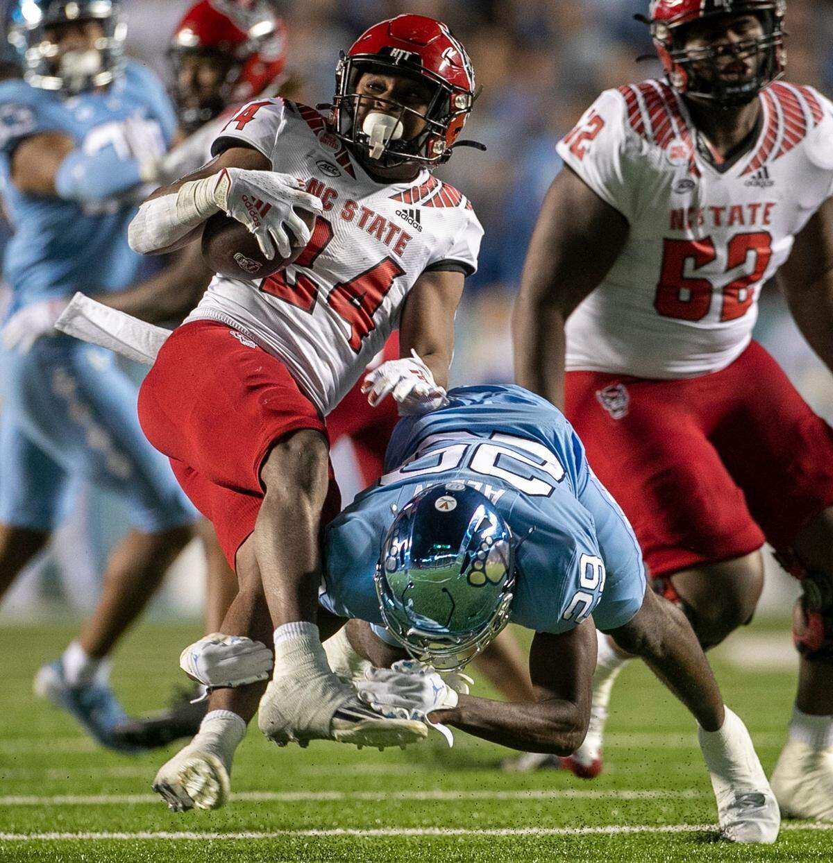 N.C. State’s Michael Allen (24) is stopped for a five-yard loss by North Carolina’s Marcus Allen (29) in the fourth quarter against North Carolina on Friday, November 25, 2022 at Kenan Stadium in Chapel Hill, N.C.