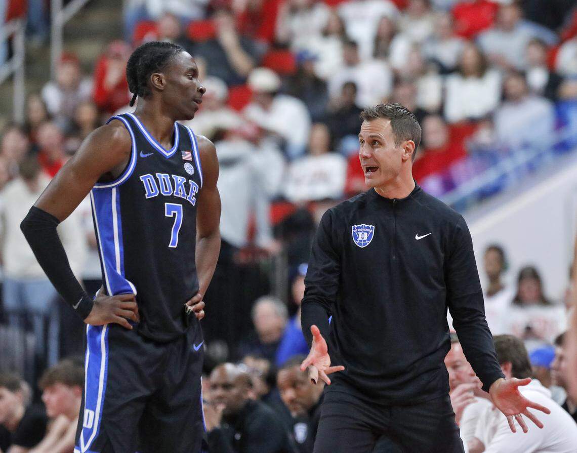 Duke head coach Jon Scheyer speaks with Dame Sarr during the second half of the Blue Devils’ 93-64 win over N.C. State on Monday, March 2, 2026, at Lenovo Center in Raleigh, N.C. 