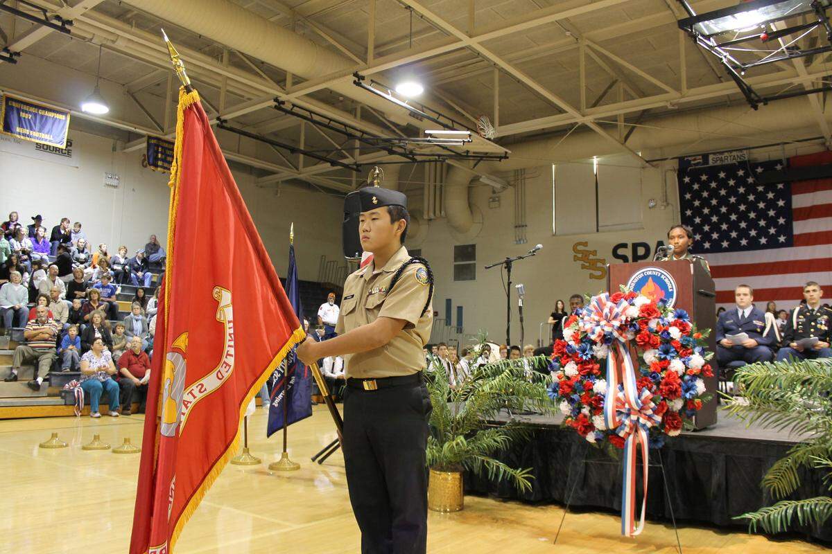 Clayton High student Simon Garren holds the U.S. Marine Corps flag at the Nov. 11 Veterans Day ceremony at Smithfield-Selma High School in this 2013 file photo.