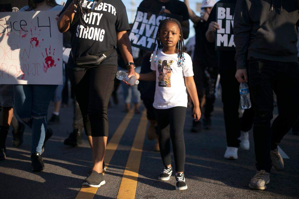 Demonstrators with their children in tow march down Ehringhaus Street calling for justice in the Andrew Brown Jr. case on Thursday, May 20, 2021 in Elizabeth City, N.C.