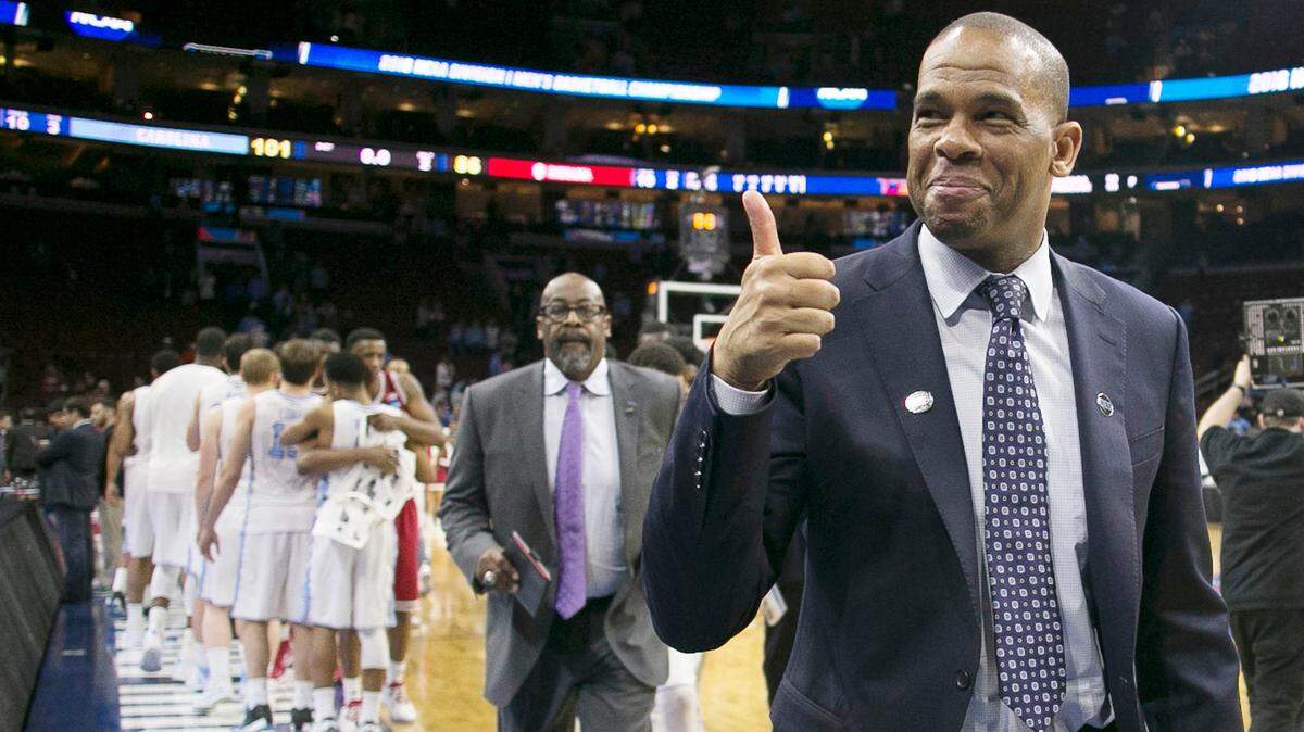 North Carolina assistant coach Hubert Davis gives a thumbs up to fans as he leaves the court following the Tar Heels‚Äô 101-86 victory over Indiana on Friday, March 25, 2016 in the NCAA East Regional semi-finals at the Wells Fargo Center in Philadelphia, Pa.