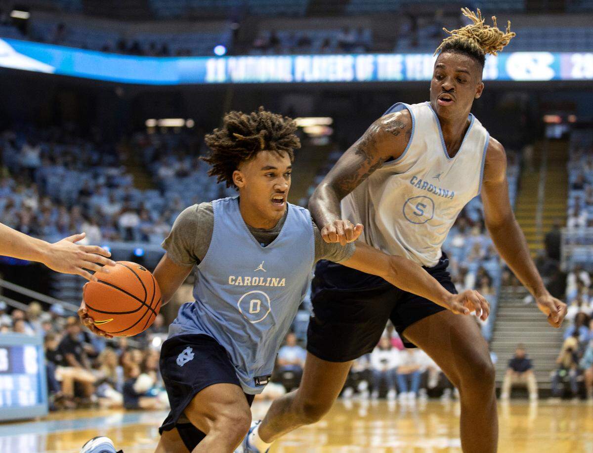 Seth Trimble drives past Armando Bacot during a scrimmage at “Live Action with Carolina Basketball” at the Dean E. Smith Center on Friday, Oct. 7, 2022, in Chapel Hill, N.C.