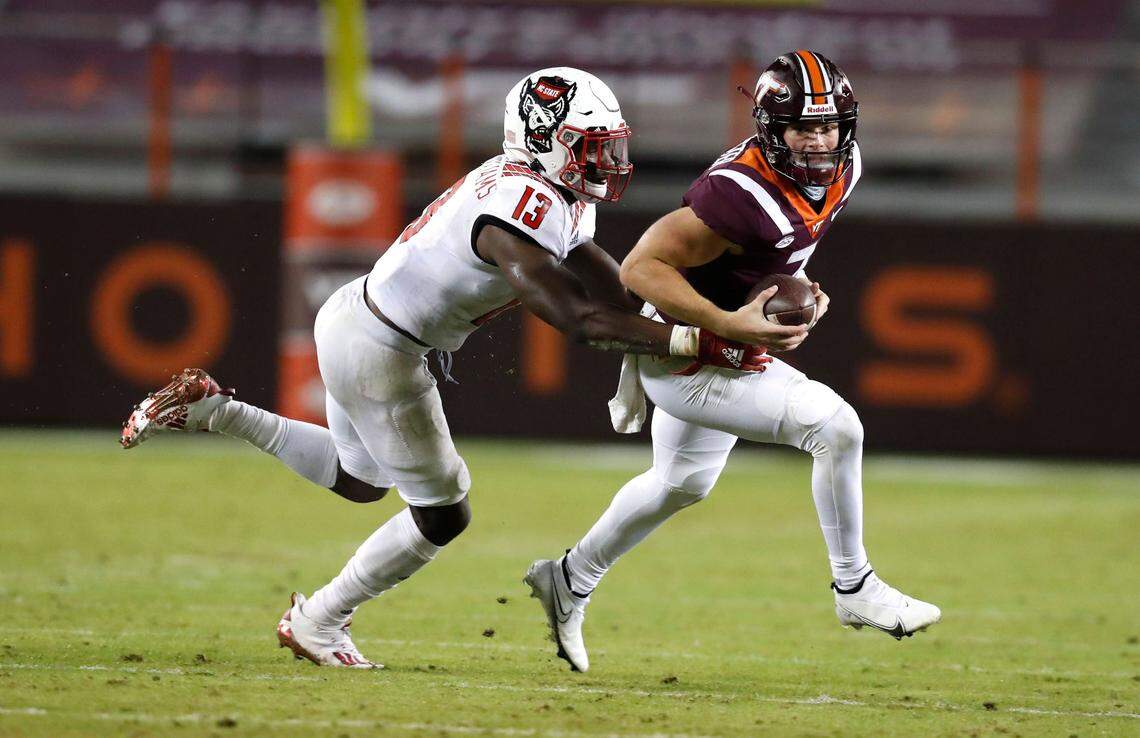 N.C. State defensive back Tyler Baker-Williams (13) sacks Virginia Tech quarterback Braxton Burmeister (3) during the second half of Virginia Tech’s 45-24 victory over N.C. State at Lane Stadium in Blacksburg, VA Saturday, Sept. 26, 2020.
