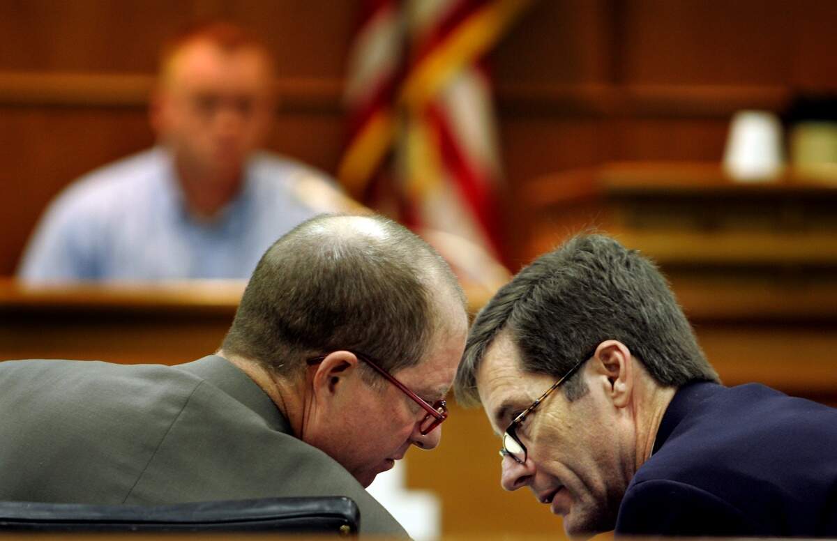 Assistant District Attorney Howard Cummings, left, chats with then-District Attorney Colon Willoughby during the Matthew Grant trial in 2004. The two attorneys have been friends for years, and Willoughby once talked Cummings out of dropping out of law school.