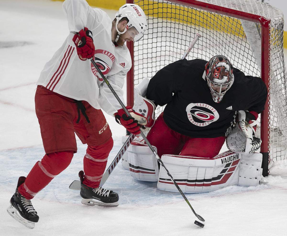 Carolina Hurricanes’ Warren Foegele (13) tries to score on goalie Petr Mrazek (34) during their practice on Saturday, May 11, 2019 at TD Garden in Boston as they prepare for Game Two of the Eastern Conference Finals against the Boston Bruins.