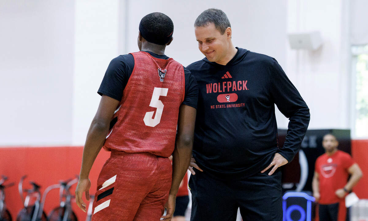 N.C. State head coach Will Wade talks with Tre Holloman (5) during the Wolfpack’s first official practice on Sept. 22, 2025, in Raleigh.