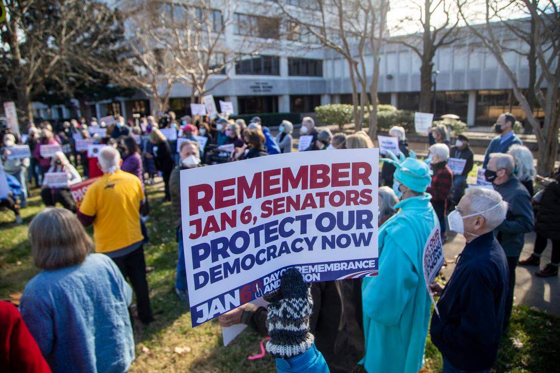 About 150 people demonstrate outside the Federal Building on New Bern Avenue in Raleigh Thursday, Jan.6 2022 on the one year anniversary of the U.S. Capitol attack. The protest organized by the North Carolina Poor People’s Campaign urged lawmakers to pass the Freedom to Vote Act and the Protecting Our Democracy Act.
