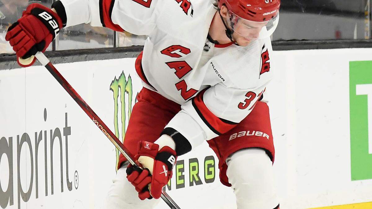 Carolina Hurricanes right wing Andrei Svechnikov (37) flips the puck on the blade of his stick prior to scoring a goal during the second period against the Boston Bruins at TD Garden.