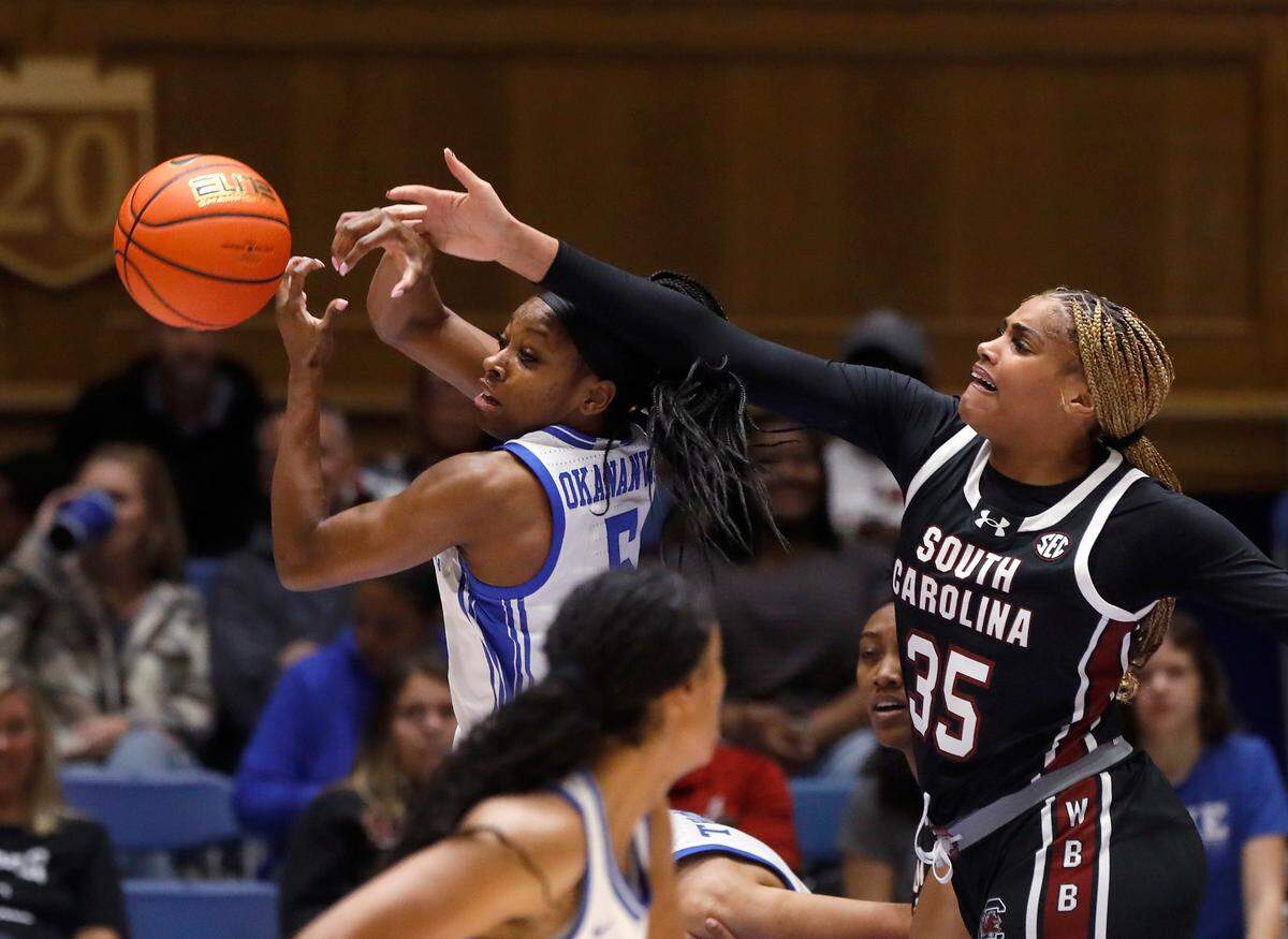 Duke’s Oluchi Okananwa and South Carolina’s Sakima Walker reach for a loose ball during the first half of the Blue Devils’ 77-61 loss on Sunday, Dec. 3, 2023, at Cameron Indoor Stadium in Durham, N.C.