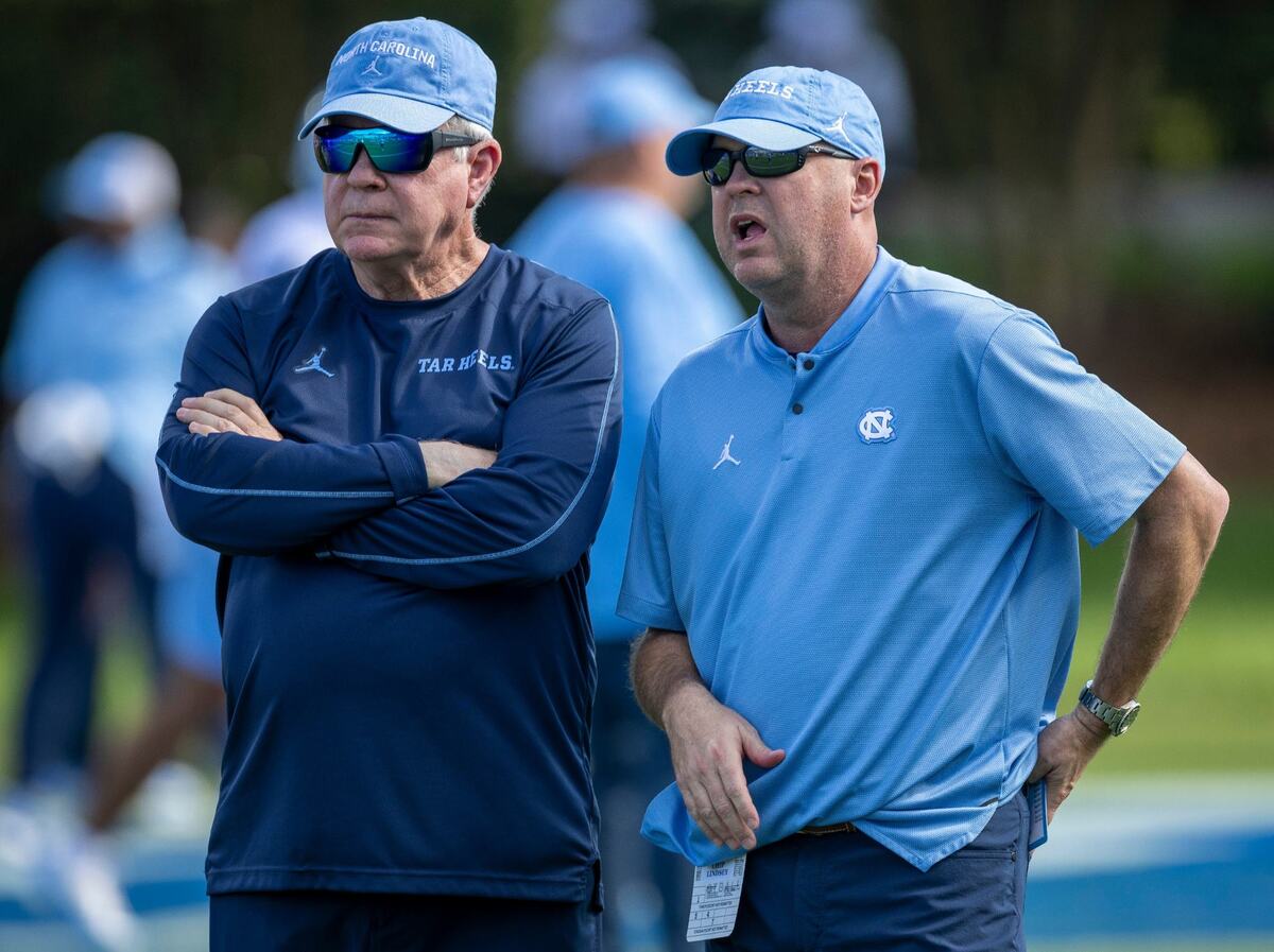 North Carolina coach Mack Brown and offensive coordinator Chip Lindsey watch their players warm up for their game against Duke on Saturday, September 28, 2024 at Wallace Wade Stadium in Durham, N.C.