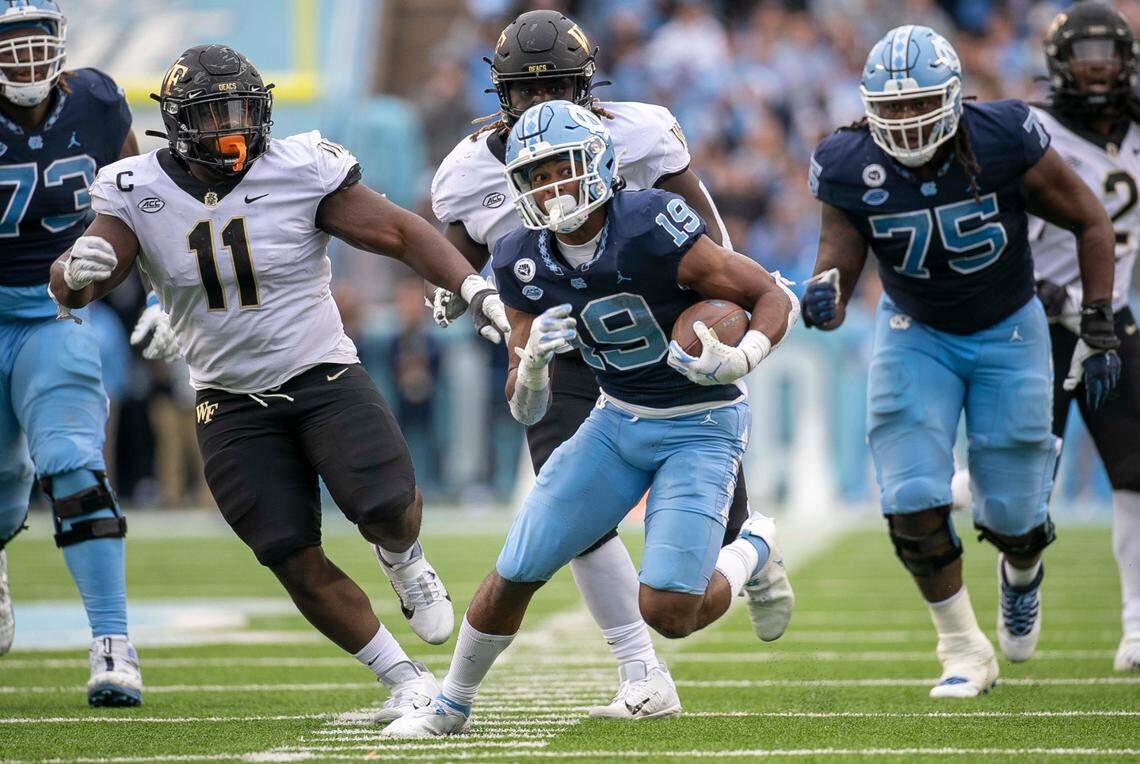 North Carolina running back Ty Chandler (19) breaks open on a 22-yard gain to set up the game winning field goal in the fourth quarter against Wake Forest on Saturday, November 6, 2021 at Kenan Stadium in Chapel Hill, N.C. Chandler rushed for 213 yards and four touchdowns in the Tar Heels’ 58-55 victory.