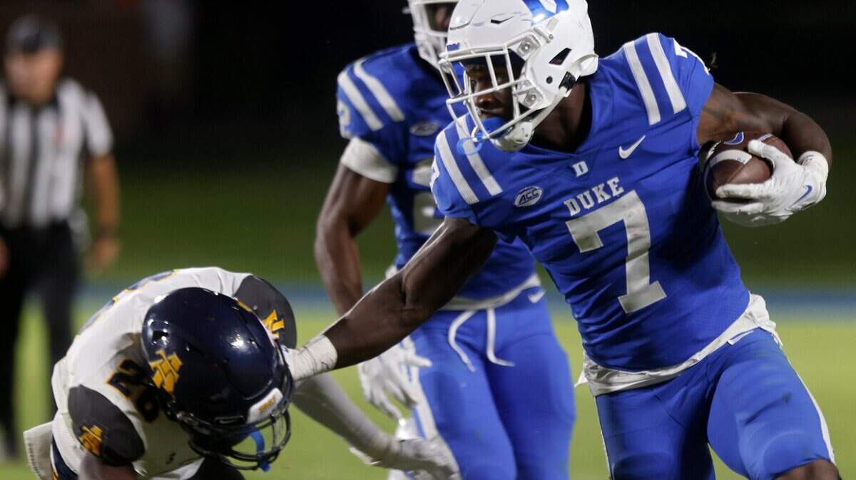 Duke Blue Devils running back Jordan Waters fends off North Carolina A&T Aggies defensive back Ty Williams Jr. during the second half of Dukes game against North Carolina A&T at Wallace Wade Stadium in Durham, N.C. on Saturday, Sept. 17, 2022.