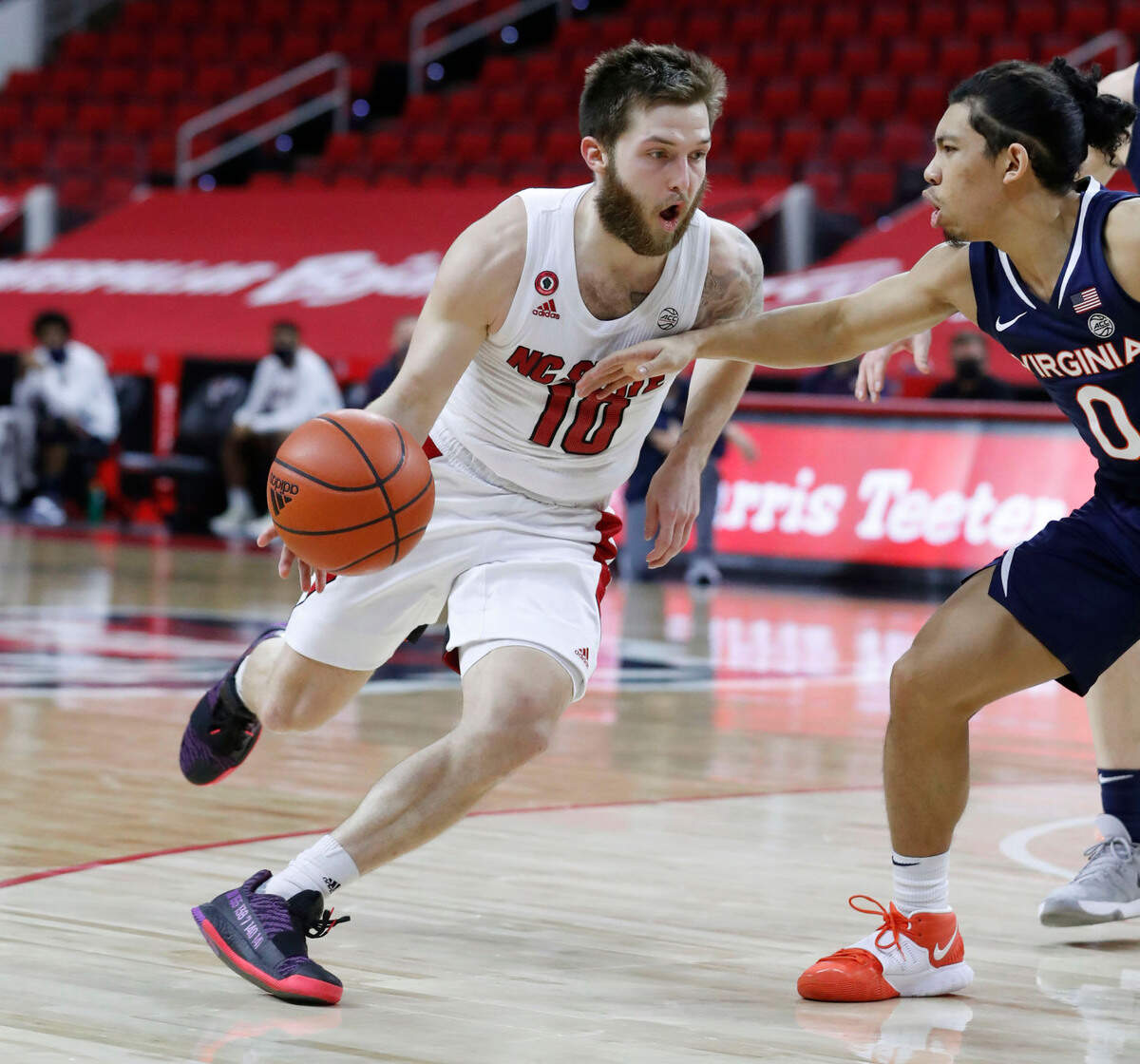 N.C. State’s Braxton Beverly (10) drives around Virginia’s Kihei Clark (0) during the second half of Virginia’s 64-57 victory over N.C. State at PNC Arena in Raleigh, N.C., Wednesday, February 3, 2021.