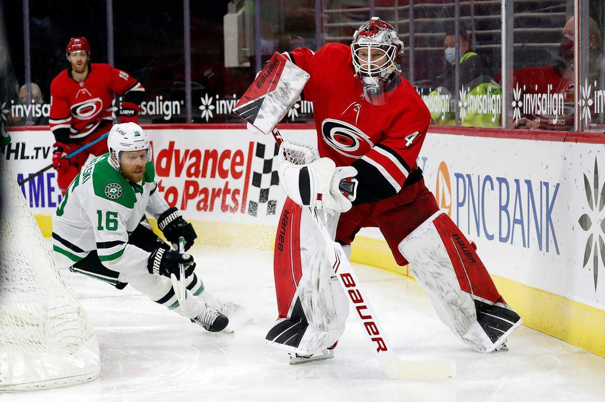 Carolina Hurricanes goaltender James Reimer (47) clears the puck from a charging Dallas Stars’ Joe Pavelski (16) during the first period of an NHL hockey game in Raleigh, N.C., Sunday, Jan. 31, 2021. (AP Photo/Karl B DeBlaker)