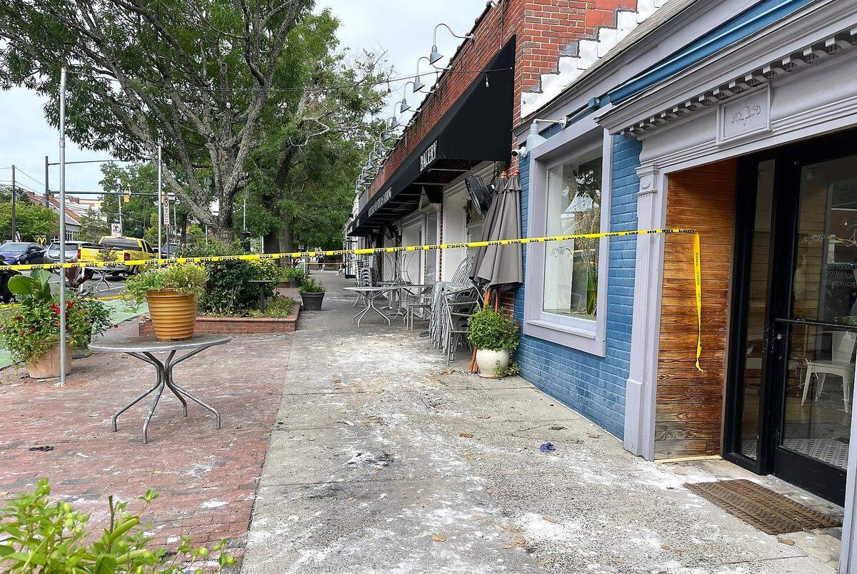 Bits of charred wood and paper were stuck to the sidewalk Monday morning outside Mediterranean Deli on West Franklin Street in Chapel Hill. The restaurant and four adjacent businesses are closed following a fire Saturday that gutted the restaurant.