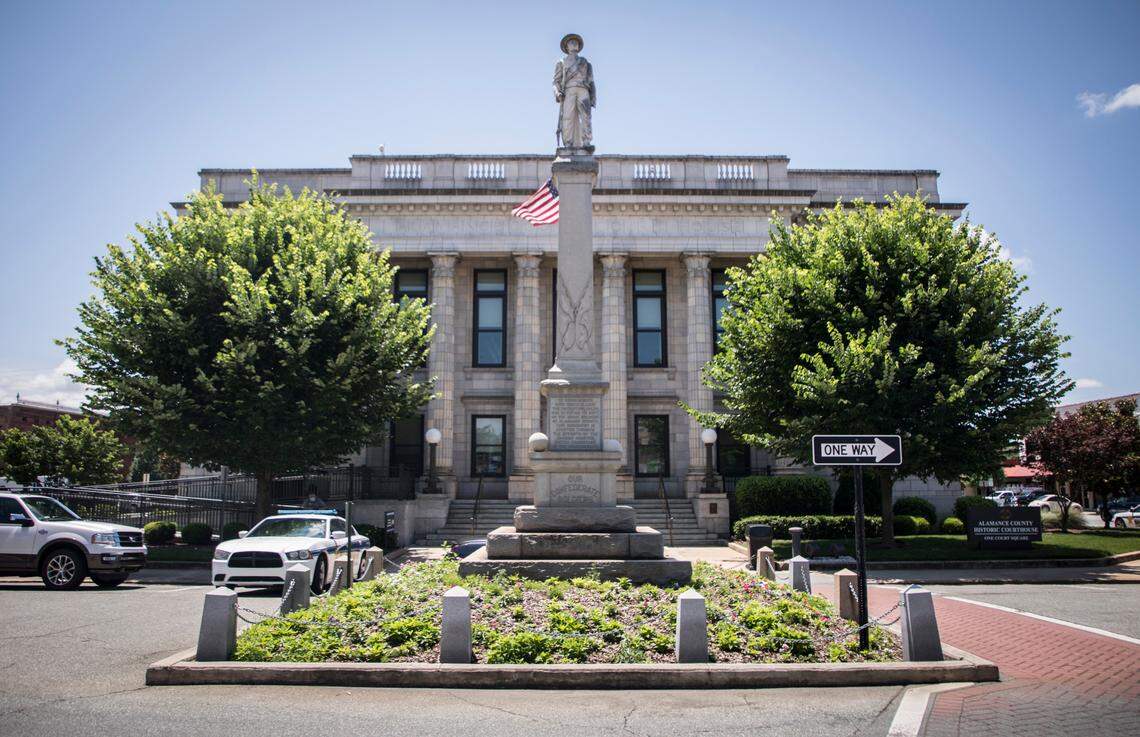 A statue of a Confederate soldier can be seen atop a monument to Confederate dead outside the Alamance County Courthouse in Graham, N.C. on Monday, June 29, 2020. The Mayor of Burlington, N.C., Ian Baltutis, joined 50 government, education and community leaders across the county on Monday in asking that the county commissioners and the city of Graham remove the monument.