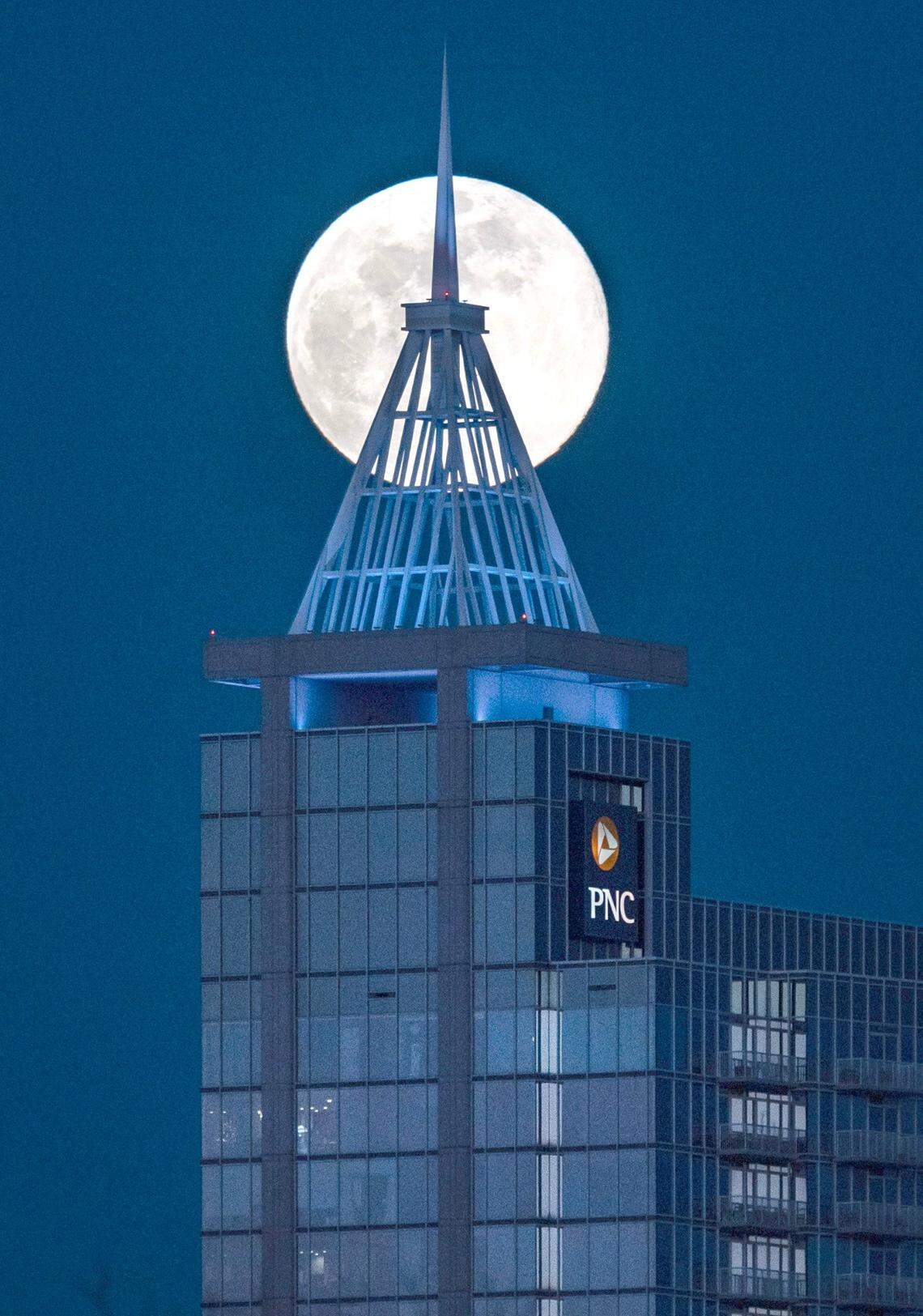 The full moon rises over downtown Raleigh as seen from Dorothea Dix Park Monday, Jan. 13, 2025.
