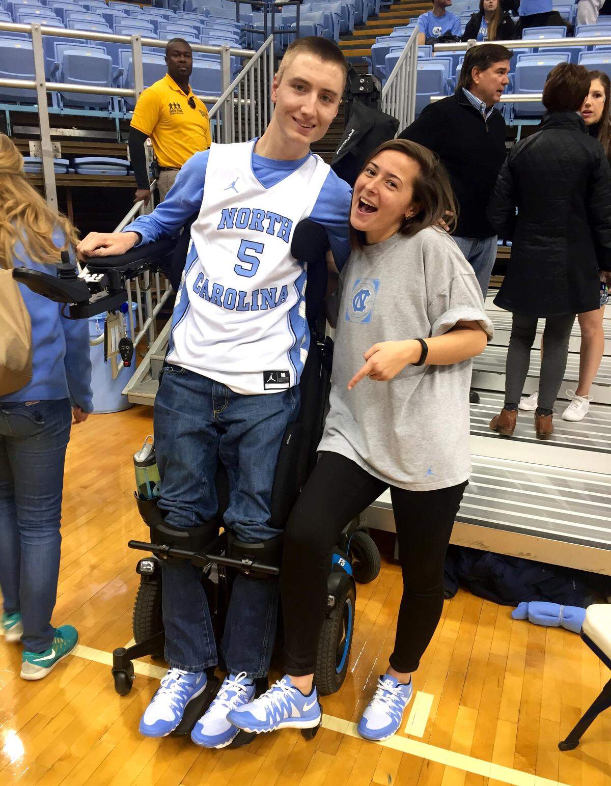 Joe Brown and his friend, Ashtyn Neuwirth, are pictured on the floor during a UNC basketball game.