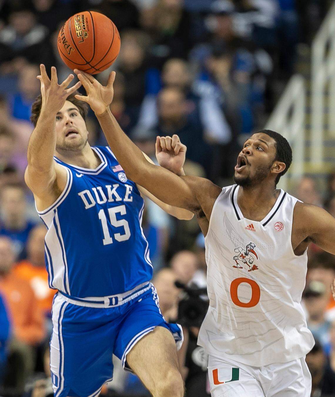 Duke’s Ryan Young (15) and Miami’s A.J. Casey (0) chase a loose ball in the second half during in the semi-finals of the ACC Tournament on Friday, March 10, 2023 at the Greensboro Coliseum in Greensboro, N.C.