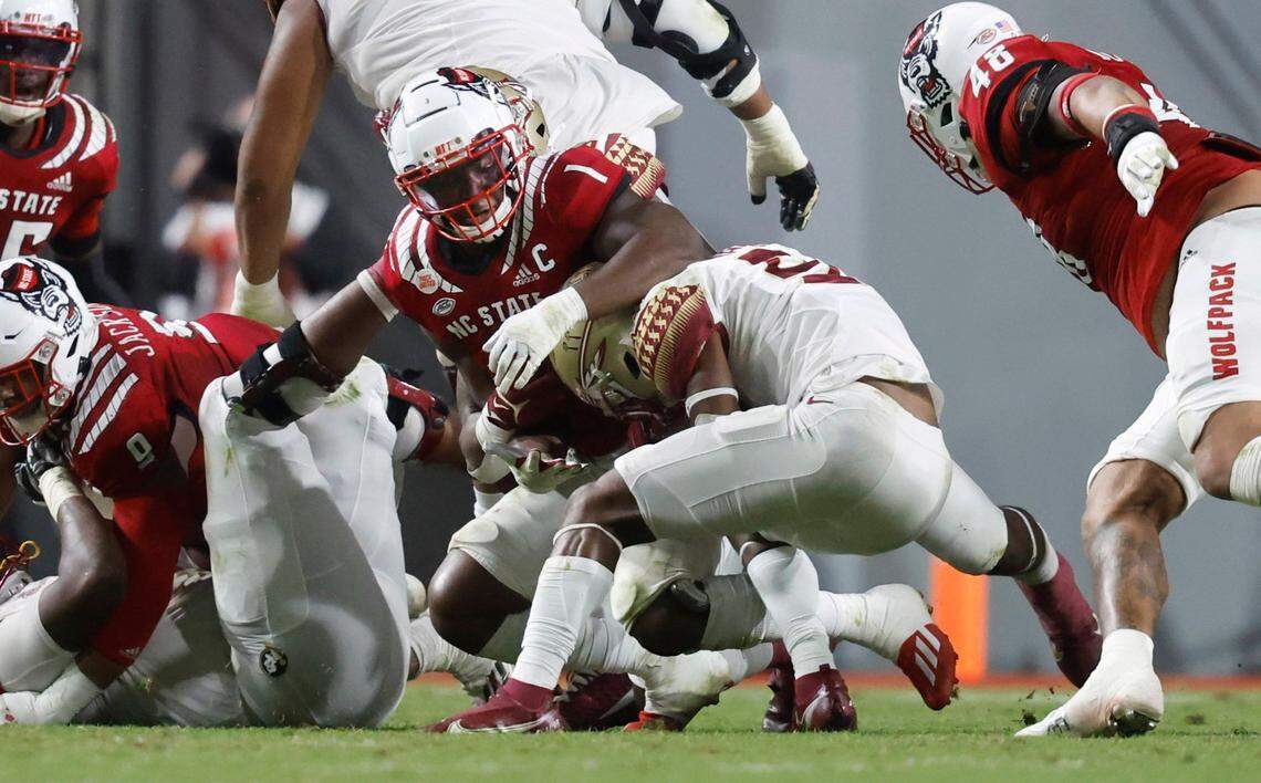 Florida State running back Lawrance Toafili (9) escapes the tackle by N.C. State linebacker Isaiah Moore (1) during the first half of N.C. State’s game against Florida State at Carter-Finley Stadium in Raleigh, N.C., Saturday, Oct. 8, 2022.