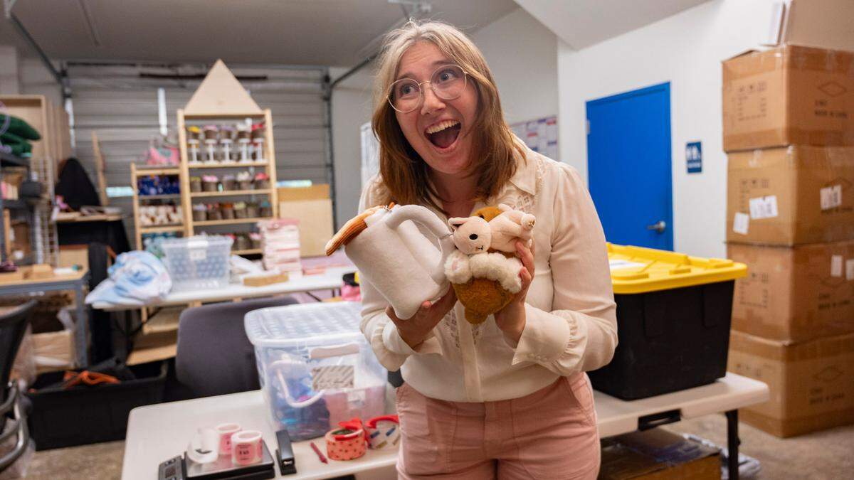 Emily Foster shows off “Koffee Kitten” one of the many designs of plushies she has inside her warehouse space in Raleigh, N.C. on Monday, July 22, 2024.