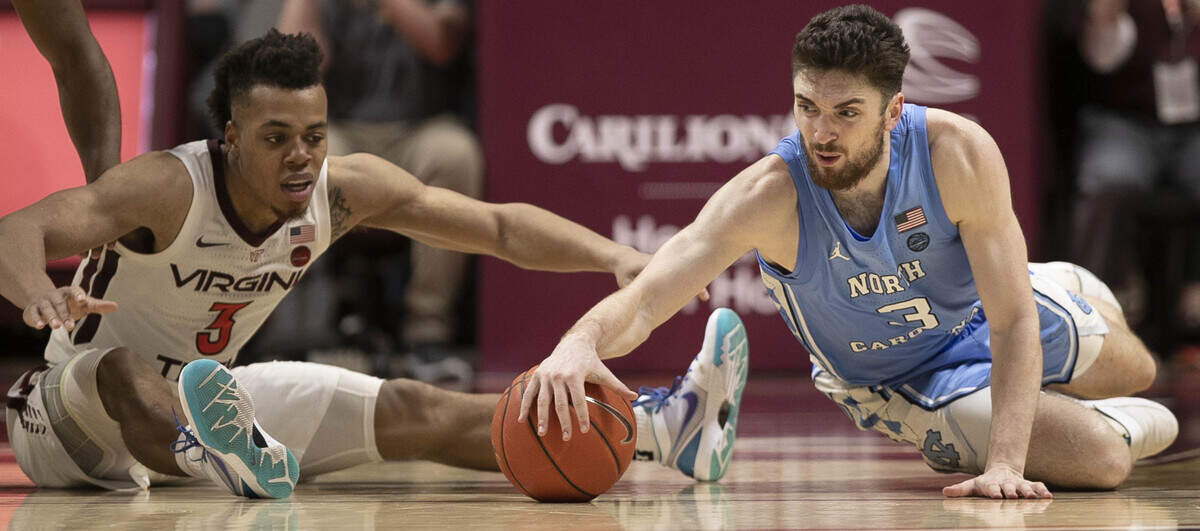 North Carolina’s Andrew Platek (3) and Virginia’s Wabissa Bede (3) go after a loose ball during the second half on Wednesday, January 22, 2020 at Cassell Coliseum in Blacksburg, Va.