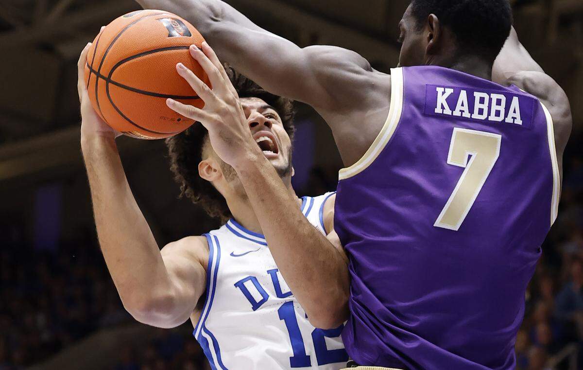 Duke’s Cameron Boozer (12) heads to the basket as Western Carolina's Abdulai Fanta Kabba (7) defends during the first half of Duke’s game against Western Carolina at Cameron Indoor Stadium in Durham, N.C., Saturday, Nov. 8, 2025.
