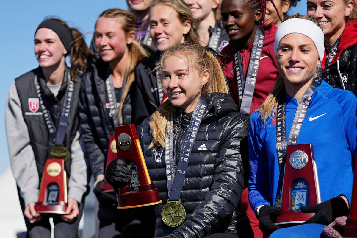 Women’s individual winner North Carolina State’s Katelyn Tuohy, center, and runner up Florida’s Parker Valby, right, pose for a group photo after the NCAA Cross Country Championships, Saturday, Nov. 19, 2022, in Stillwater, Okla. (AP Photo/Sue Ogrocki)