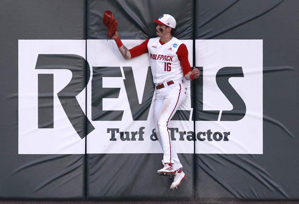 N.C. State’s Eli Serrano III (16) makes a catch against the wall of a fly ball by Bryant’s Gavin Noriega in the sixth inning during N.C. State’s 9-2 victory over Bryant in the NCAA Raleigh Regional at Doak Field Friday, May 31, 2024.