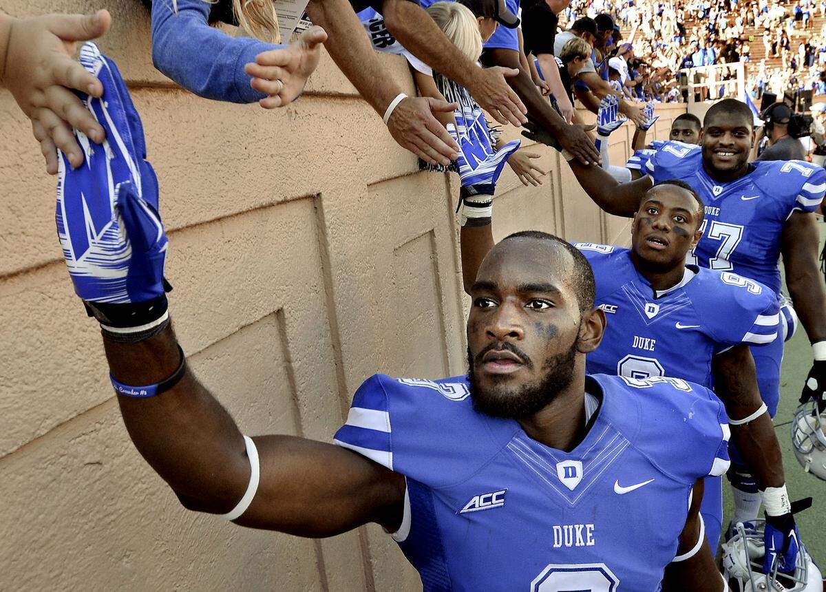 Duke wide receiver Jamison Crowder (3), running back Josh Snead (9) and guard Laken Tomlinson (77) are congratulated by fans as Duke beat Virginia 20-13 at Wallace Wade Stadium in Durham, NC Saturday, Sept. 18, 2014.