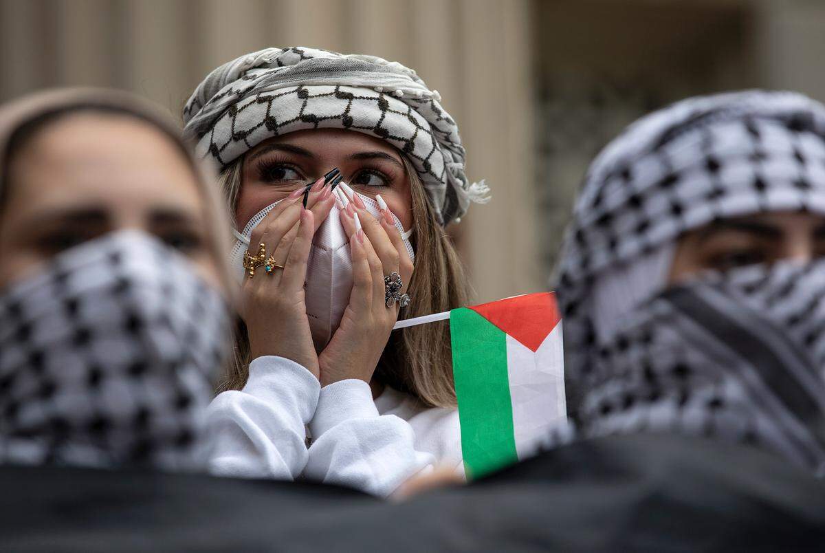 A person holds a Palestinian flag during a rally in support of Palestinians at UNC-Chapel Hill on Thursday, Oct. 12, 2023. The rally was organized by the UNC chapter of Students for Justice in Palestine.