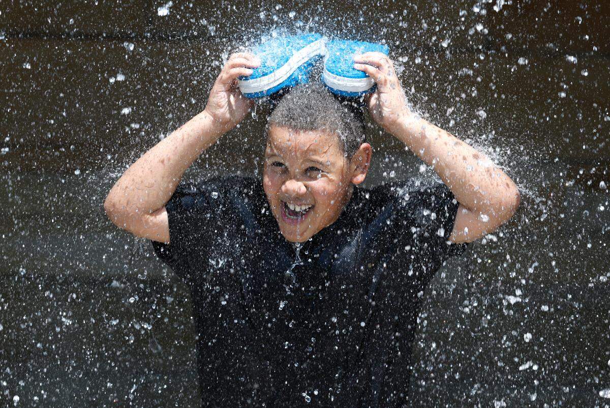 Dylan Warren, 8, of Knightdale enjoys the waterfall at Gipson Play Plaza at Dix Park during a preview day Saturday, May 24, 2025.